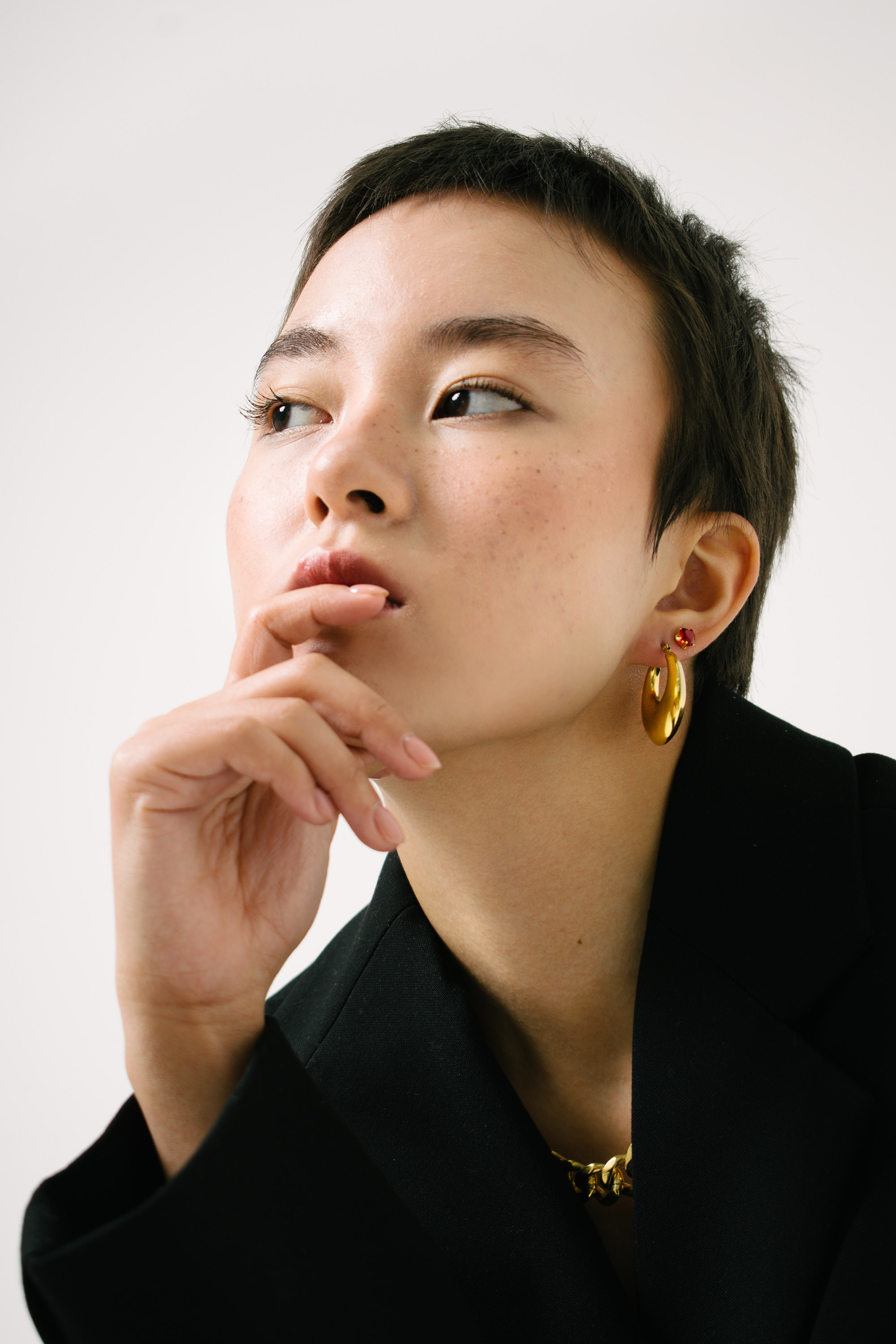 a girl with a short haircut in black blazer